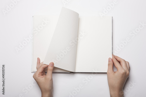 woman hand hold a book(note) isolated white. © dohee