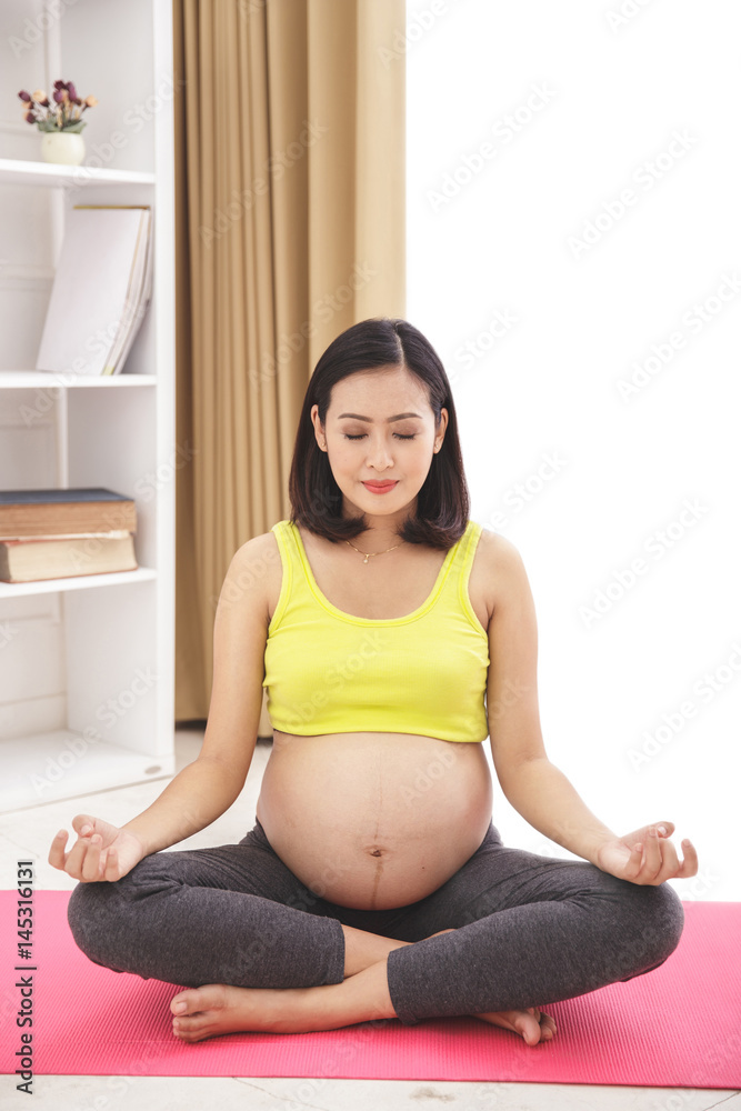 healthy pregnant woman doing meditation yoga