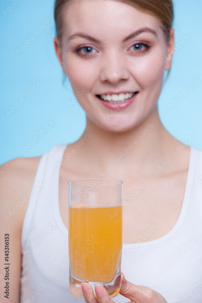 Woman holding glass with water and effervescent tablet Woman holding glass with water and effervescent tablet