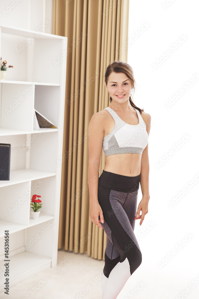 sporty girl smiling while standing