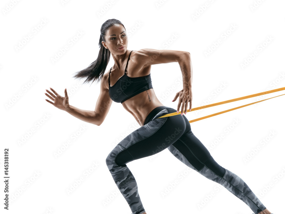 Photographie Strong woman using a resistance band in her exercise routine -  Acheter-le sur Europosters.fr