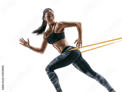 Obraz na plátně Strong woman using a resistance band in her exercise routine