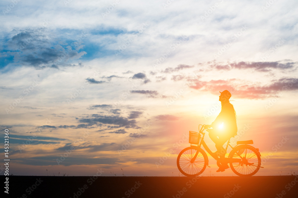 Fototapeta premium Young man ride bicycle on sunset background.