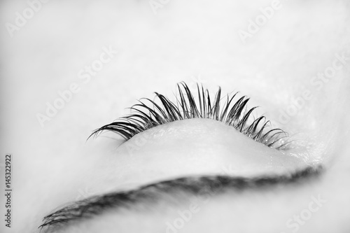 Woman on the procedure for eyelash extensions, eyelashes lamination photo