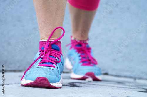 woman athlete running through the streets of the city