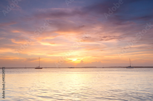 Yachts in the ocean at sunset © Nickolay Khoroshkov