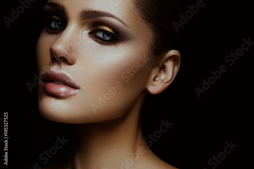 Close-up portrait of beautiful woman with bright make-up and hairstyle.