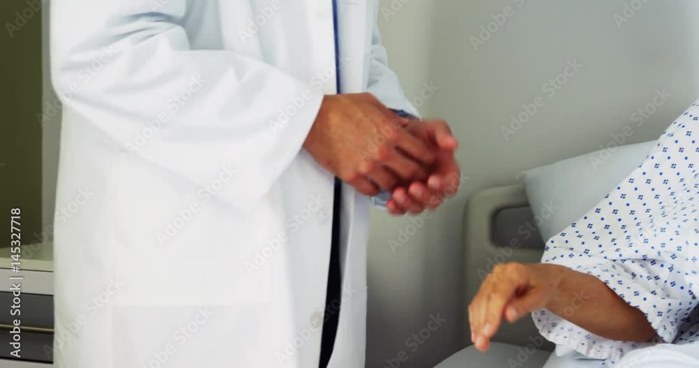 Male doctor comforting patient in the ward Male doctor comforting patient in the ward