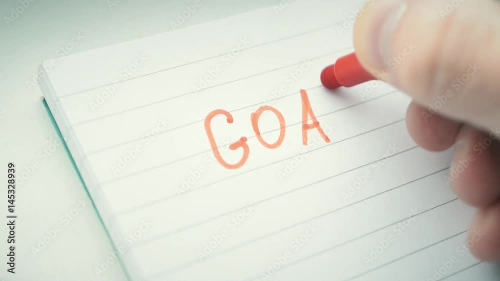 Hand writing the word GOAL with red marker in notepad with exclamationj mark, business concept Hand writing the word GOAL with red marker in notepad with exclamationj mark, business concept