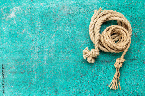 Ropes tied with knots on turquoise background