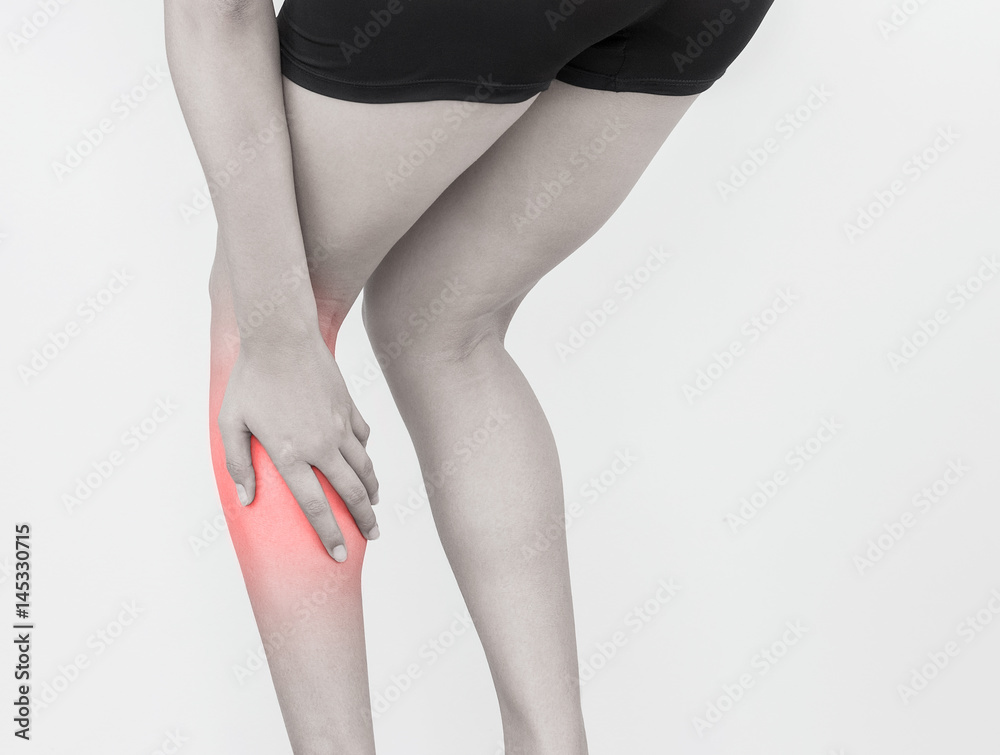 Young woman with calf leg pain on white background. Health concept