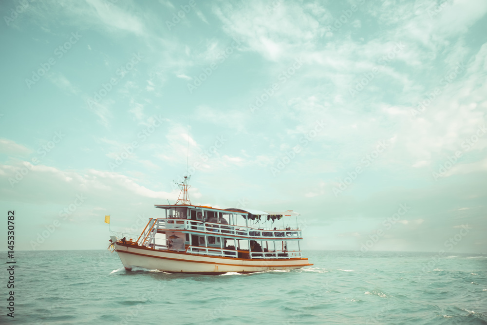 Old passenger ships floating in the ocean. boat of adventure and journey floating in sea in summer.  vintage color tone.