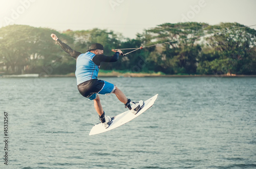 Photography wakeboarder trains in the lake