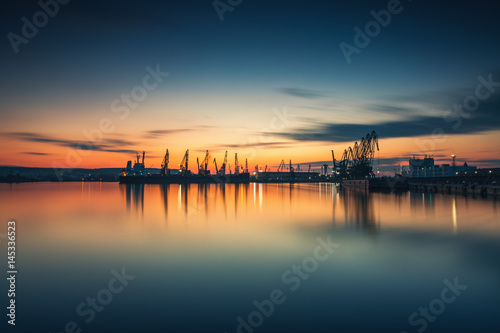 Sunset over sea port and industrial cranes, Varna