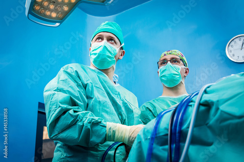 Orthopedic surgeons portrait while performing arthroscopic surgery on human patient.