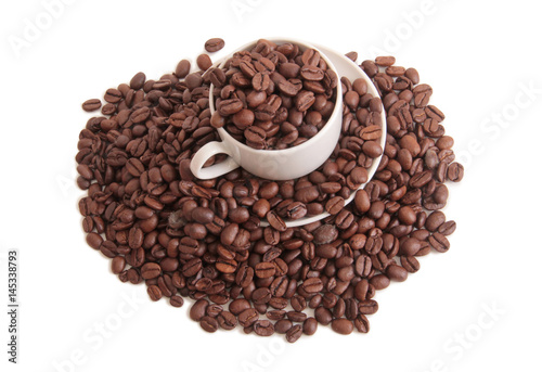 Coffee beans and a white cup on white background