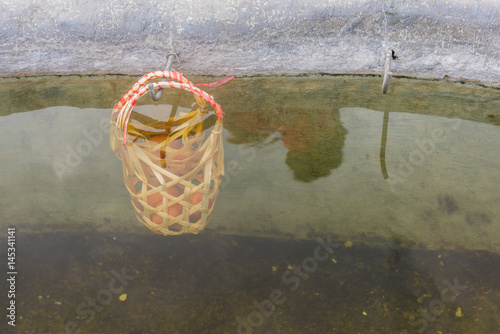 egg in bamboo basket boil in hot water photo