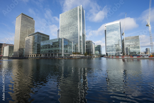 Scenic water view of the modern skyline of London reflecting in the River Thames on a bright day