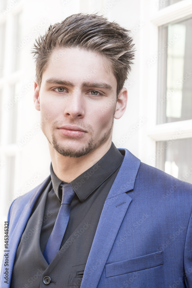 Young , handsome, male model, man or boy, posing in elegant clothes, suit and tie, outdoors. Young , handsome, male model, man or boy, posing in elegant clothes, suit and tie, outdoors.