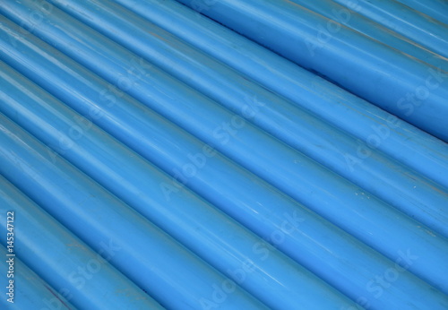 PVC plastic pipe stacked in a building site.