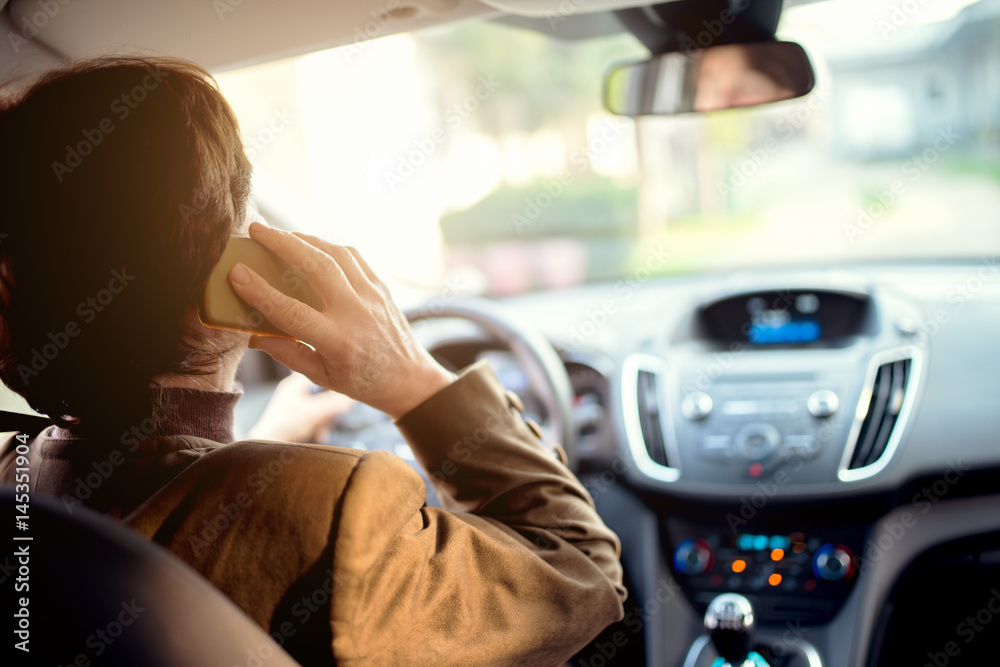 © Dusan Petkovic - Woman talking on mobile phone while driving a car. © Dusan Petkovic - Woman talking on mobile phone while driving a car.