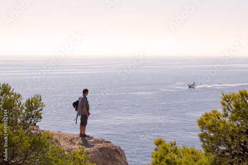 Men is looking at motor boat, Calancers