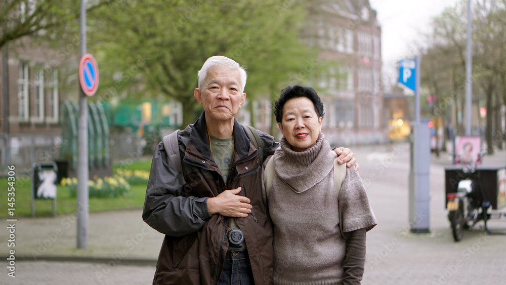 Fototapeta premium Asian senior couple traveling to Europe together having fun experience together