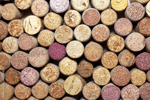 used wine corks / many wine corks / closeup of a wall of used wine corks