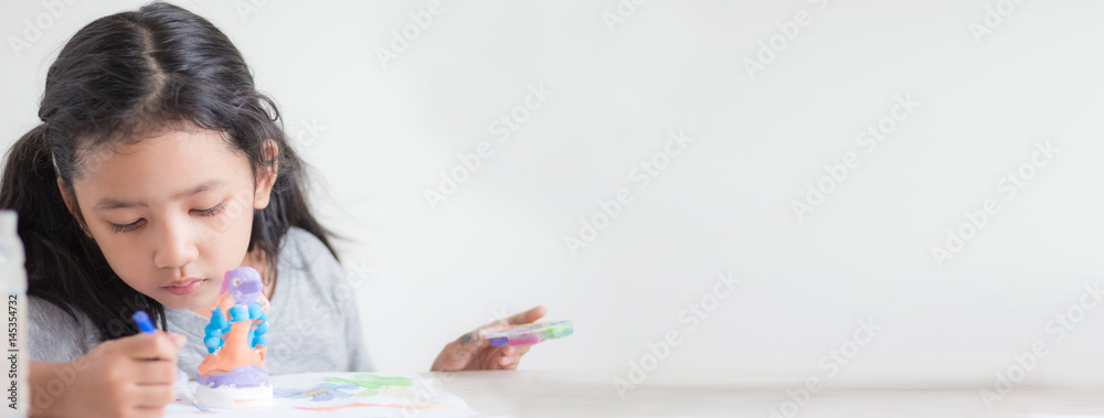 Close up shot of Asian little girl painting color shallow dept of field with copy space Close up shot of Asian little girl painting color shallow dept of field with copy space