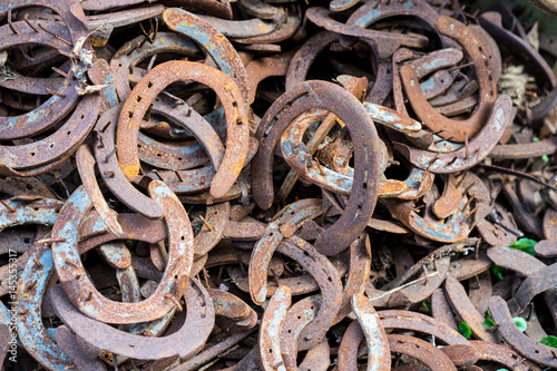 Large pile of rusty used Horseshoes