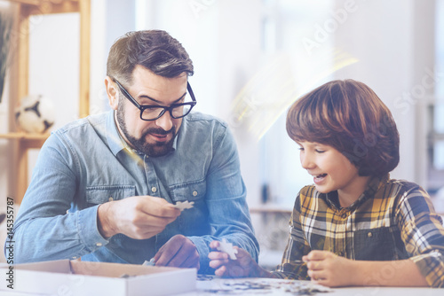 Father and son joking while playing chass photo