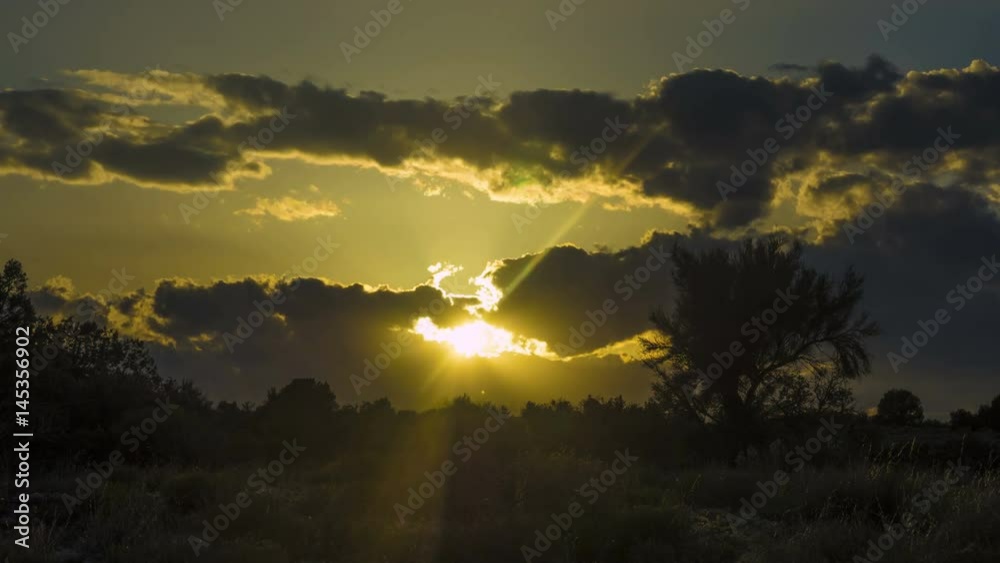 Sunset time lapse with sun rays and cloud formations