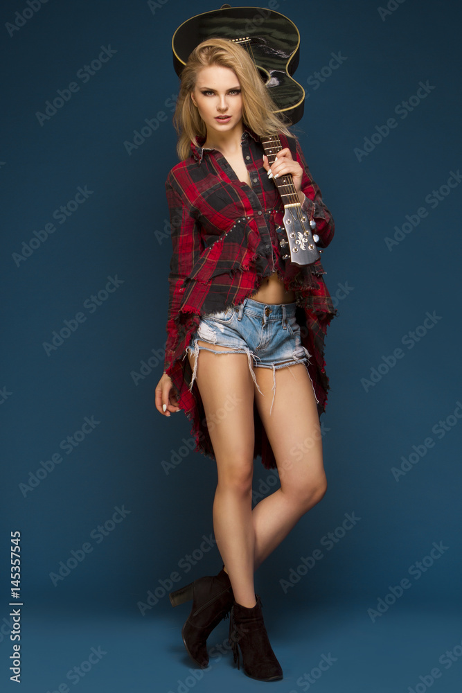 Young beautiful teenage girl playing on guitar. Concert. Hobby. Rock and roll. Young beautiful teenage girl playing on guitar. Concert. Hobby. Rock and roll.