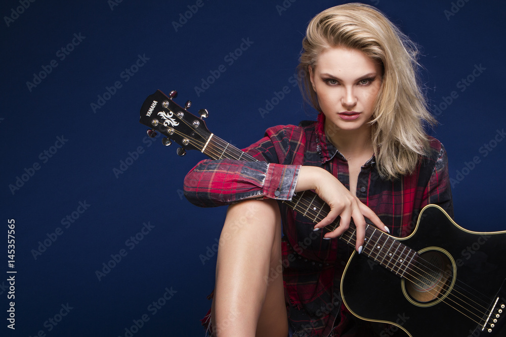 Obraz premium Young beautiful teenage girl playing on guitar. Concert. Hobby. Rock and roll.