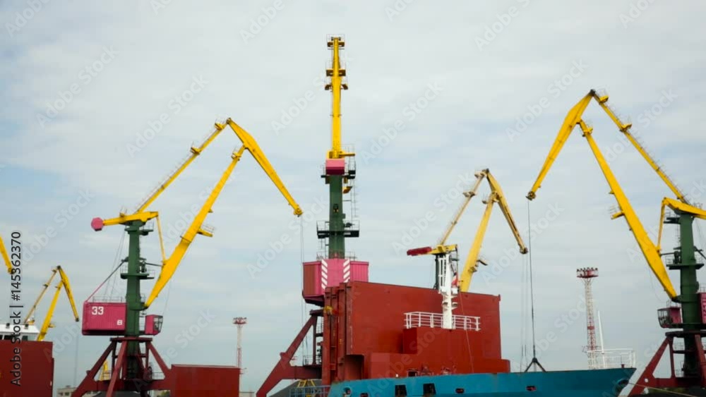Sea Port. Cranes in Dock Loading Boat. Heavy Equipment Working. Cloudy Sky Sea Port. Cranes in Dock Loading Boat. Heavy Equipment Working. Cloudy Sky