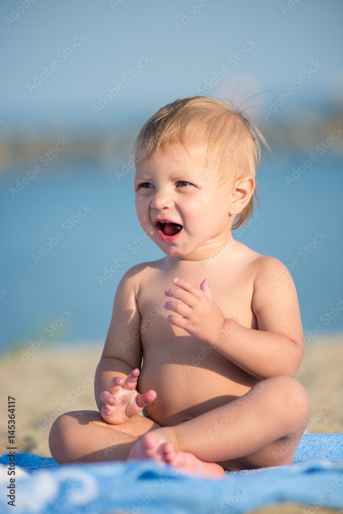 Baby playing with toys on the sandy beach near the sea. Cute little kid in sand on tropical beach. Ocean coast. Baby playing with toys on the sandy beach near the sea. Cute little kid in sand on tropical beach. Ocean coast.
