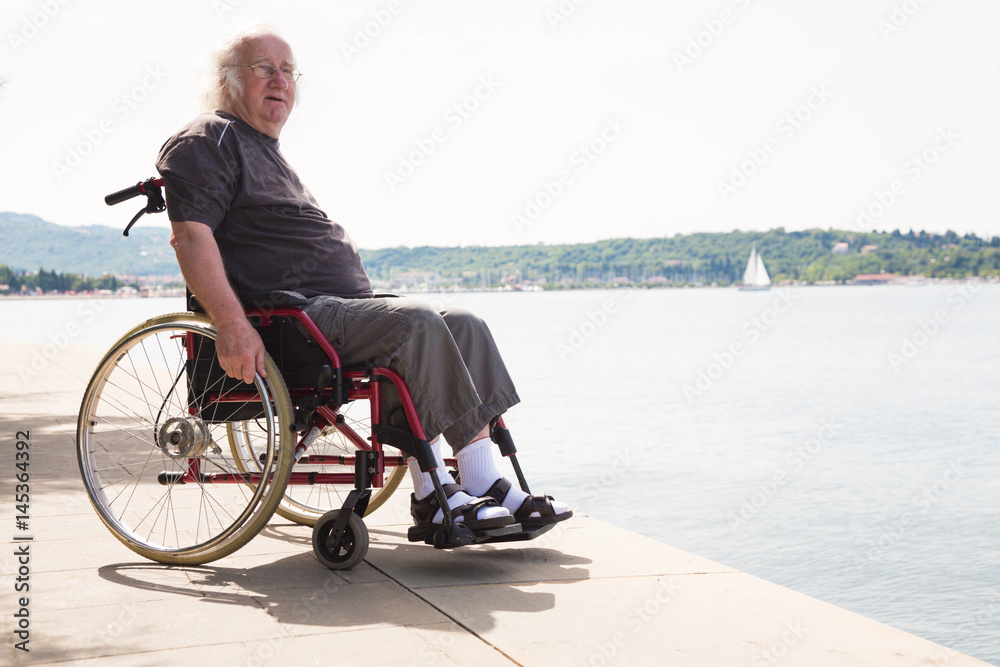 Happy Old Man In Wheelchair Looking At The Sea