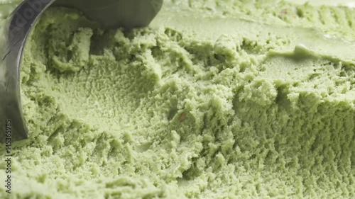 Slow motion of pistachio ice cream being scooped close up, 60fps prores footage photo