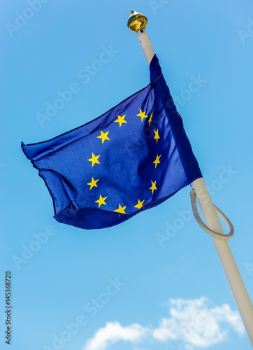 flag of the European Union with clouds underneath symbolizing darkening photo