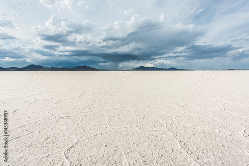 White Bonneville Salt Flats landscape with rain storm clouds in distance
