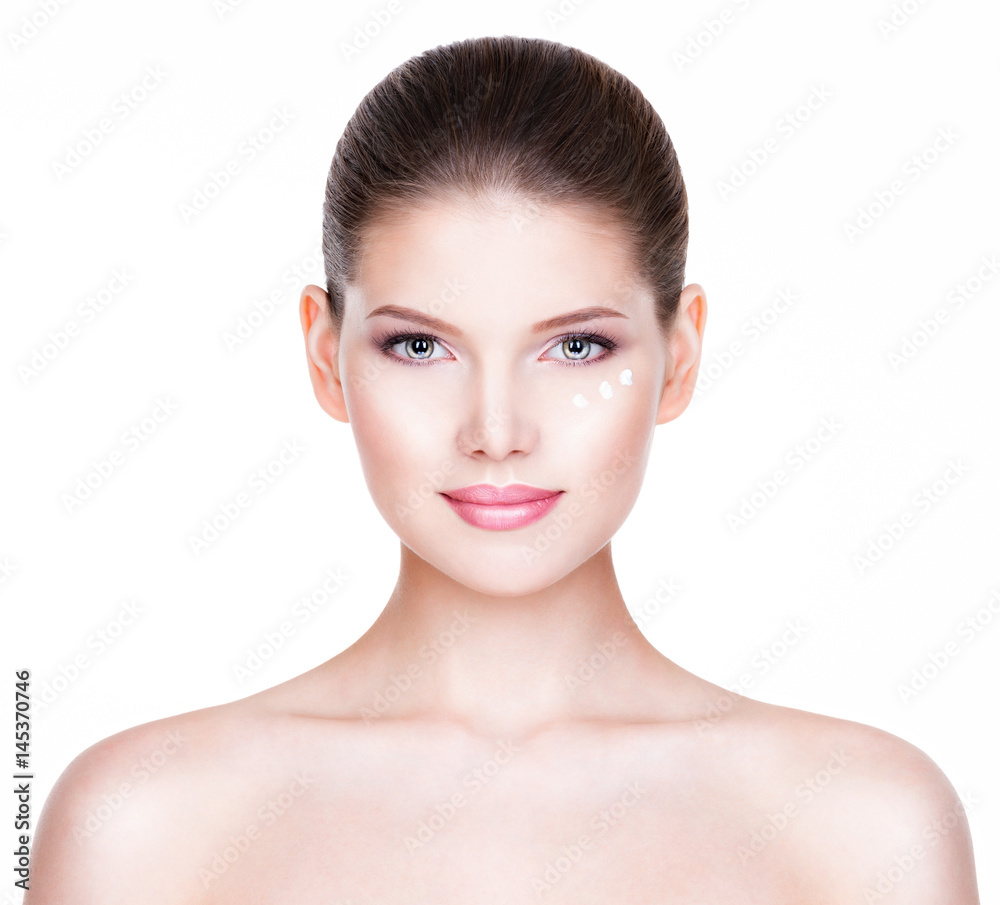 Beautiful woman with cosmetic cream under the eyes. Beautiful woman with cosmetic cream under the eyes.