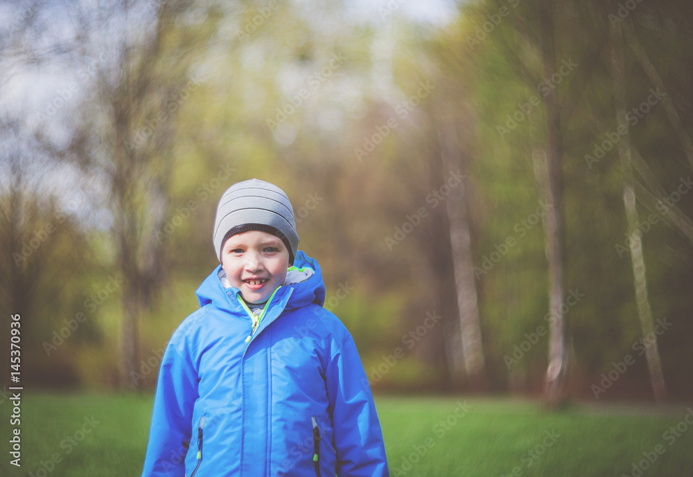 Smiling happy little boy during walk in park vintage filter Smiling happy little boy during walk in park vintage filter