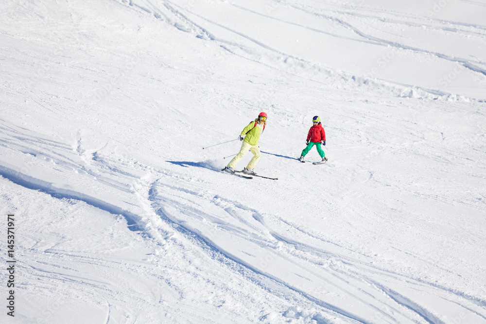 Active family hitting the slope at snowy mountains