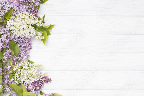 lilac flowers on the white wooden background.