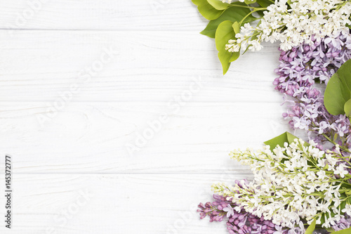 lilac flowers on the white wooden background.