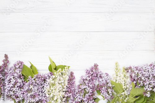lilac flowers on the white wooden background.