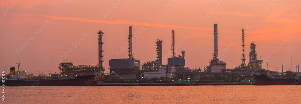 Fototapeta premium Refinery tower in petrochemical industrial plant with river