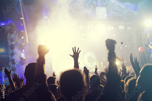 crowd, happy people enjoying rock concert, raised up hands and clapping of pleasure, active night life concept 
