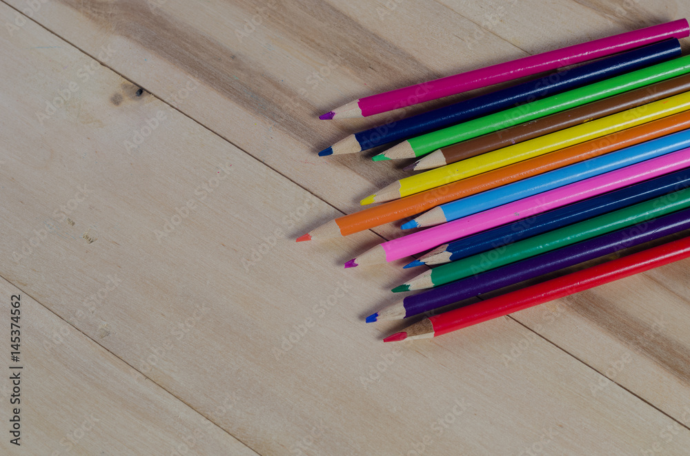 Obraz premium color pencils on white paper on the table. View from above