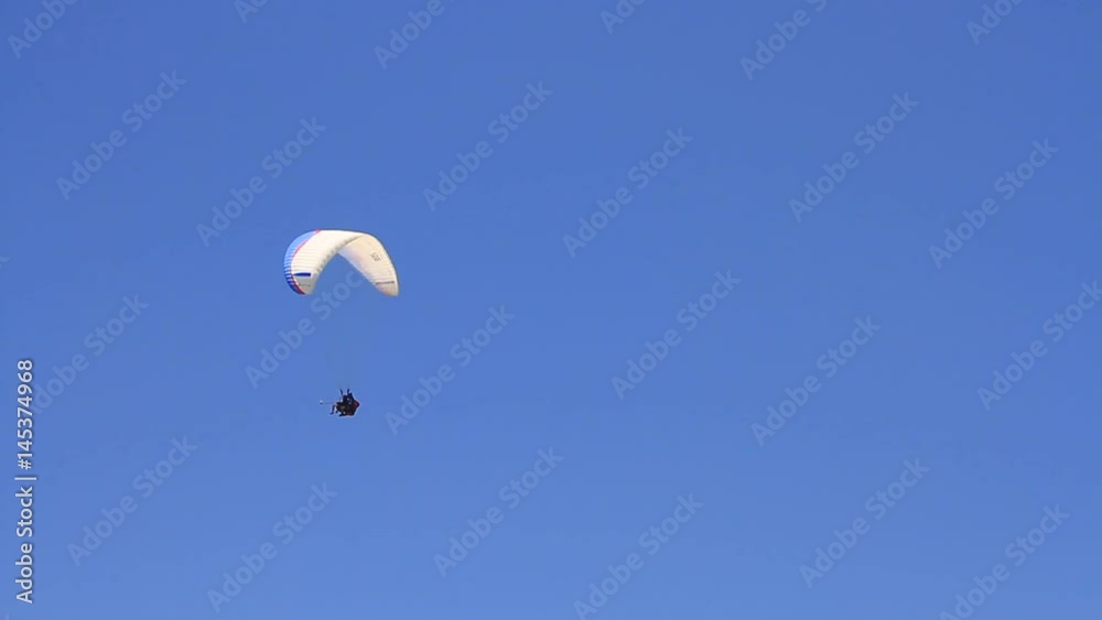 Paraglider pilot maneuvering the parachute for landing. Mount Babadag and Oludeniz Beach well known amongst paragliders Paraglider pilot maneuvering the parachute for landing. Mount Babadag and Oludeniz Beach well known amongst paragliders